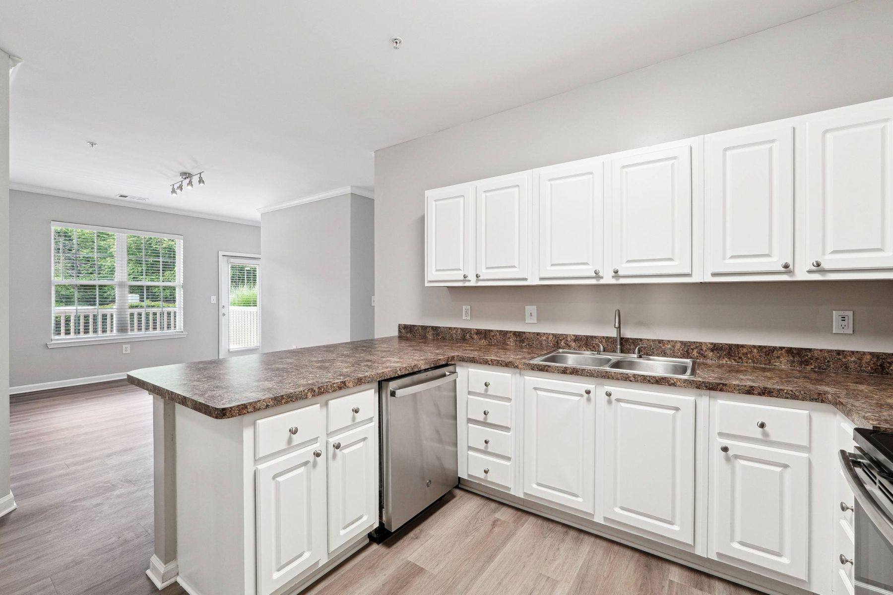 Luxury apartment kitchen with stainless steel appliances, granite countertops, and lots of storage space